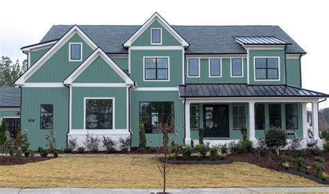 metal roof on mint green house|green house exterior ideas.